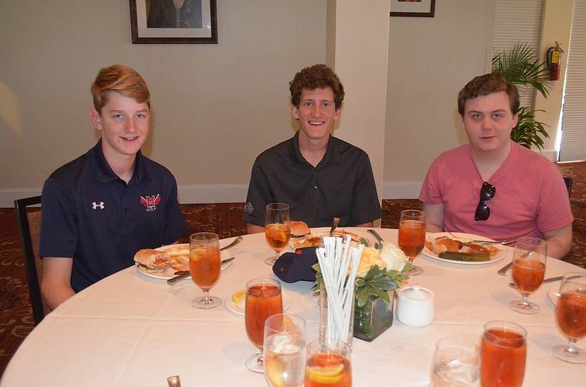 Harrison Fuller, Parry Foster and Gunner Anzaldi, who helped caddy the private round of golf for sponsors