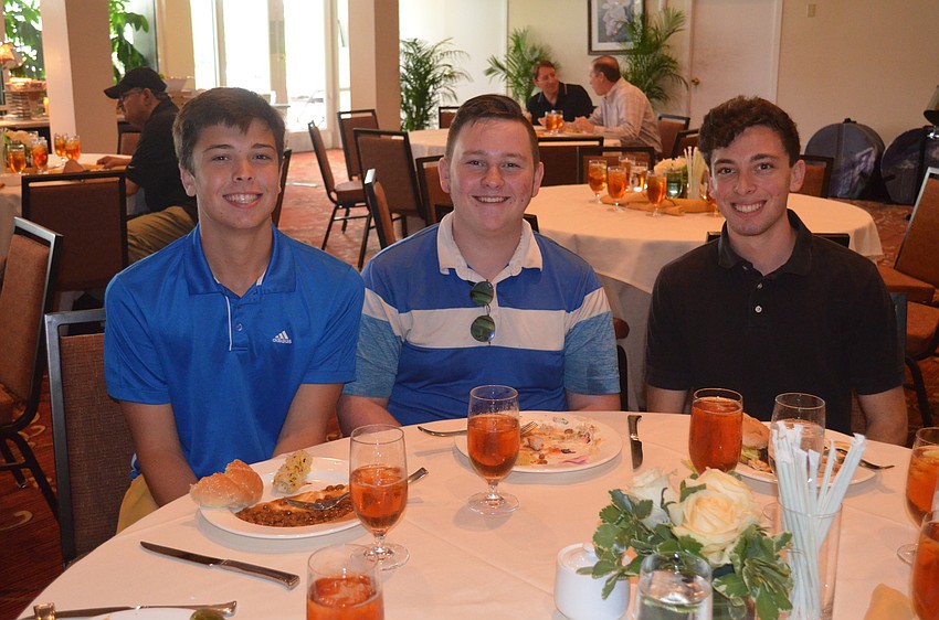 Matt Mardones, Sylan Tribble and Ryan Gilman, who helped caddy the private round of golf for sponsors