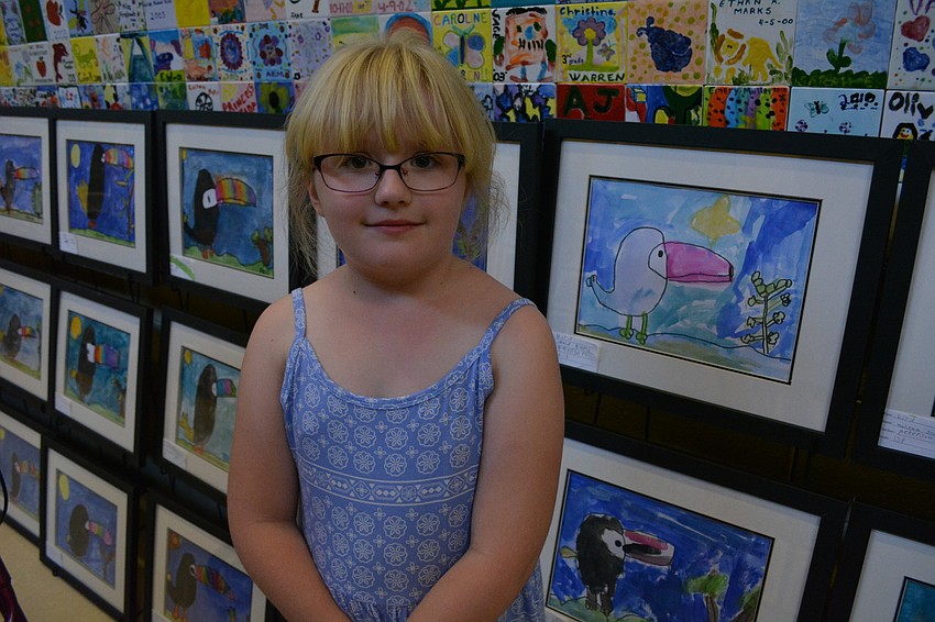 Lana Kuhl, 7, finds her toucan painting to show her parents, Jennifer and Warren, and Aunt Joyce Slate and Grandma Rosalind Slate.