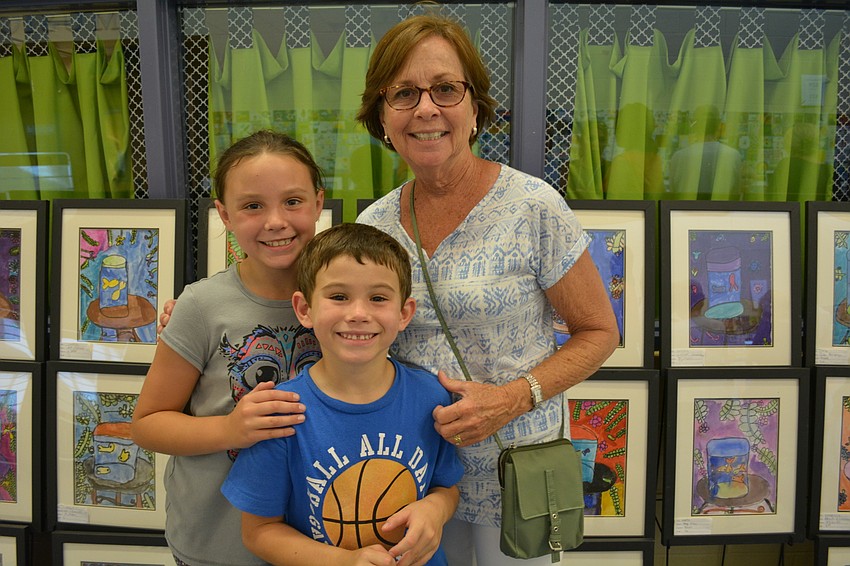 Amanda and Nicholas Renteria hunt down their artwork for their grandma, Elaine Haines.