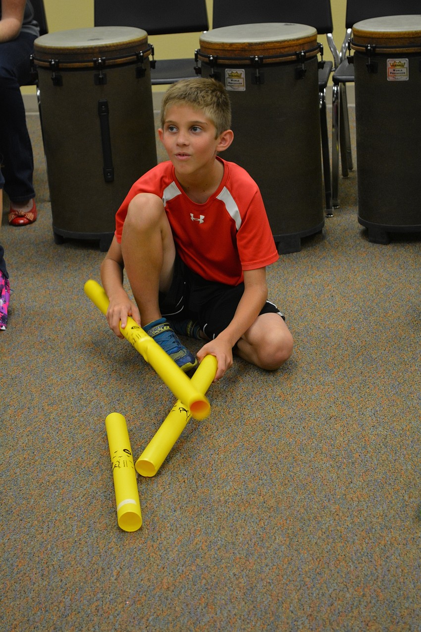 Mason Smithers, 9, uses pipes to make various sounds.