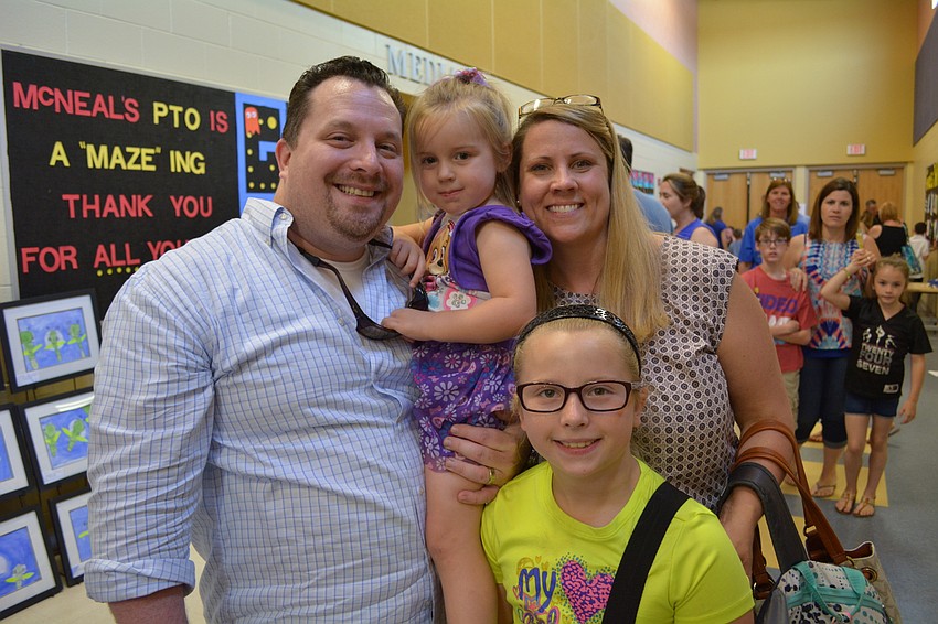 Jospeh and Jessica Prunty attend with their daughters, Mackenzie, 3, center, and Madison, 9, front.