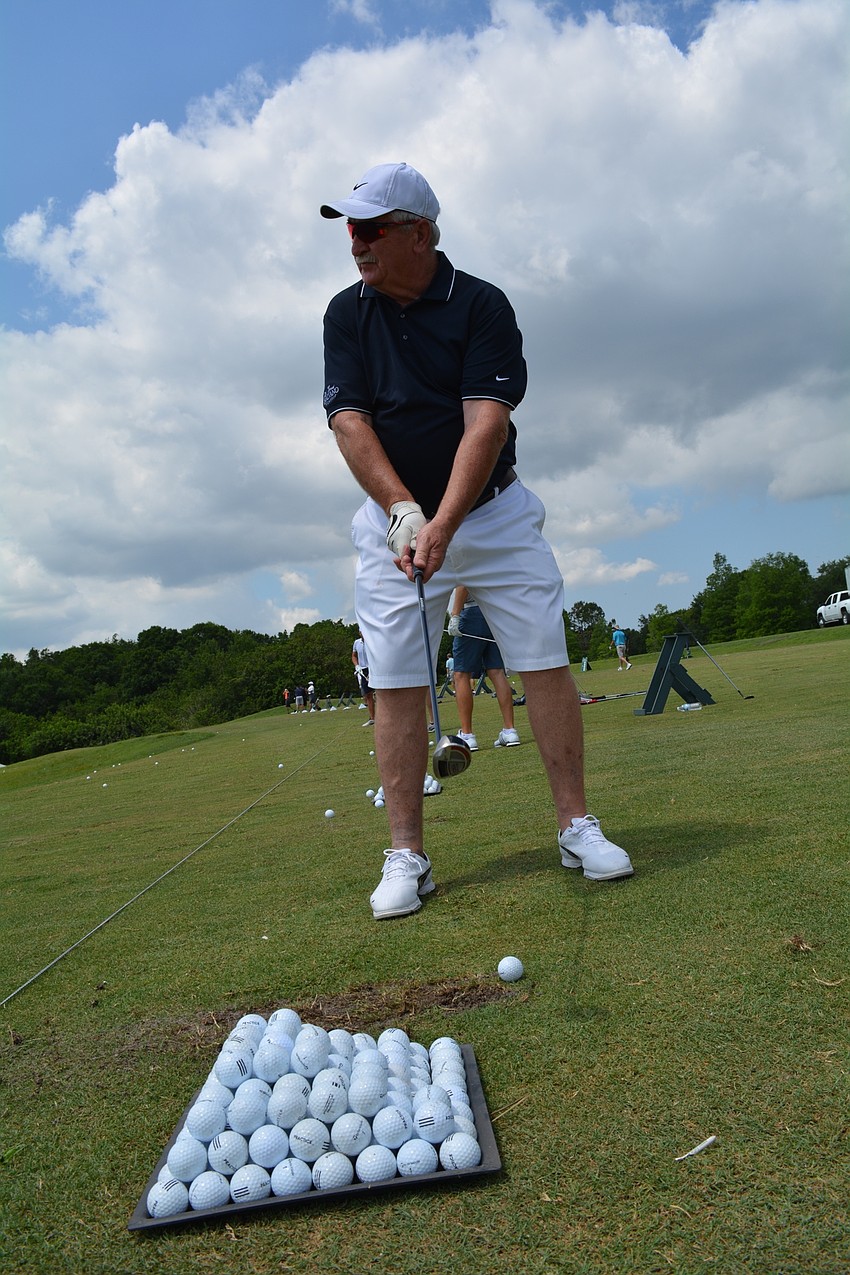 Laurie Gregan, of Palm Beach, practices his swing before the tournament starts.