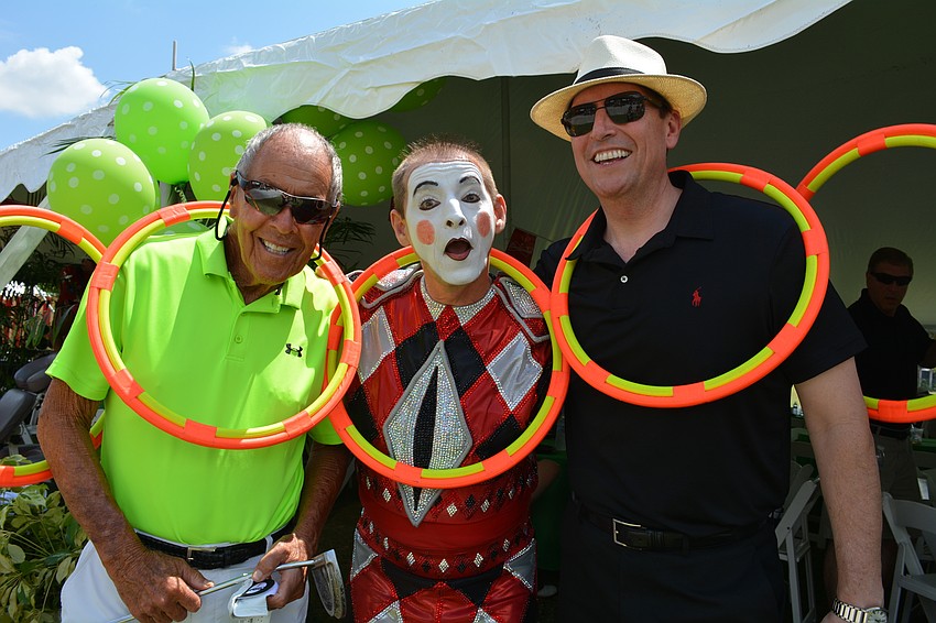 Nick Bollettieri, founder of IMG Academy, poses with Circus Arts Conservatory performer Vladimir Tsarkov and Sen. Bill Galvano.