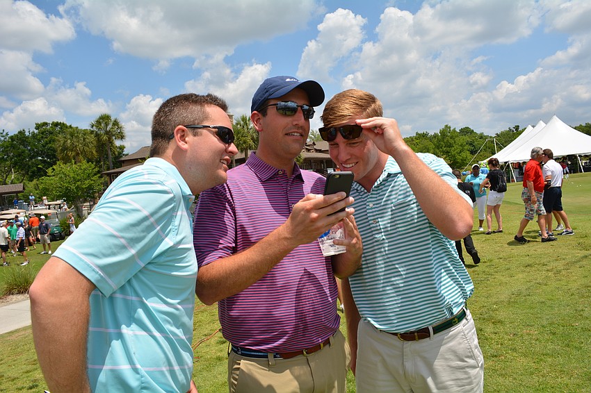 Greg Black, Cory Guzzo and Ben Smith watch video of the human cannonball.