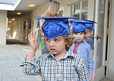 Jack Williams fusses with his tassel as he waits to graduate.