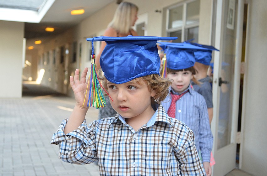Jack Williams fusses with his tassel as he waits to graduate.