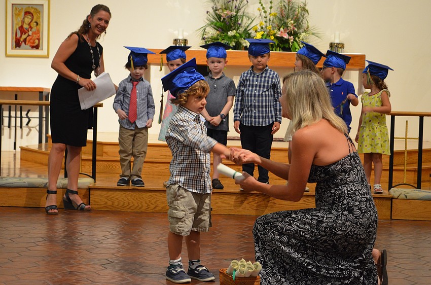 Jack Williams receives his diploma from Carol Mahon.