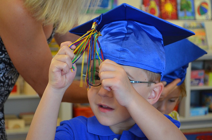 Justin McNally enjoys playing with the strands of his tassel.