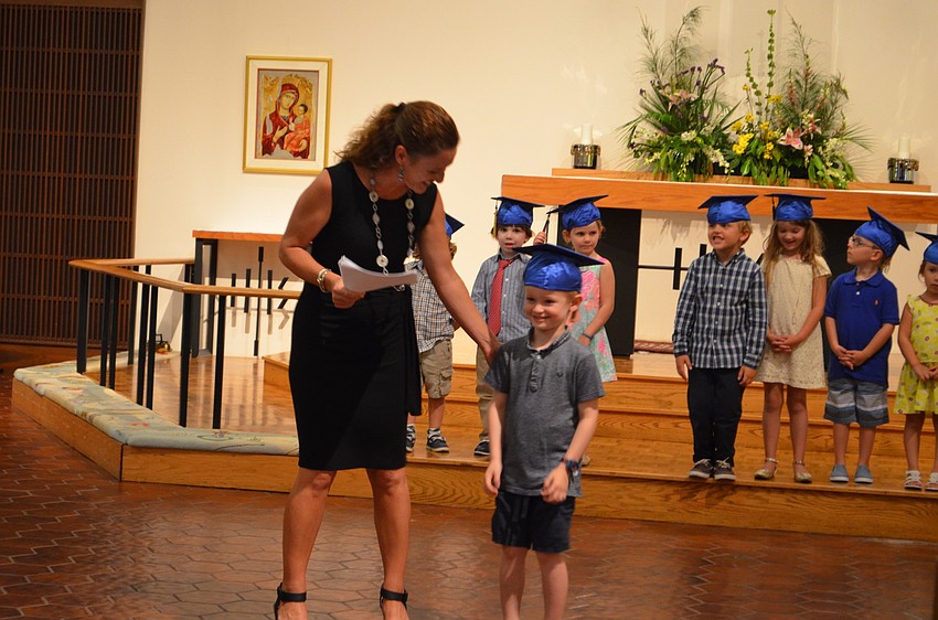 St. Boniface Preschool Director Sarah Schebel introduces graduate Liam Stevens.