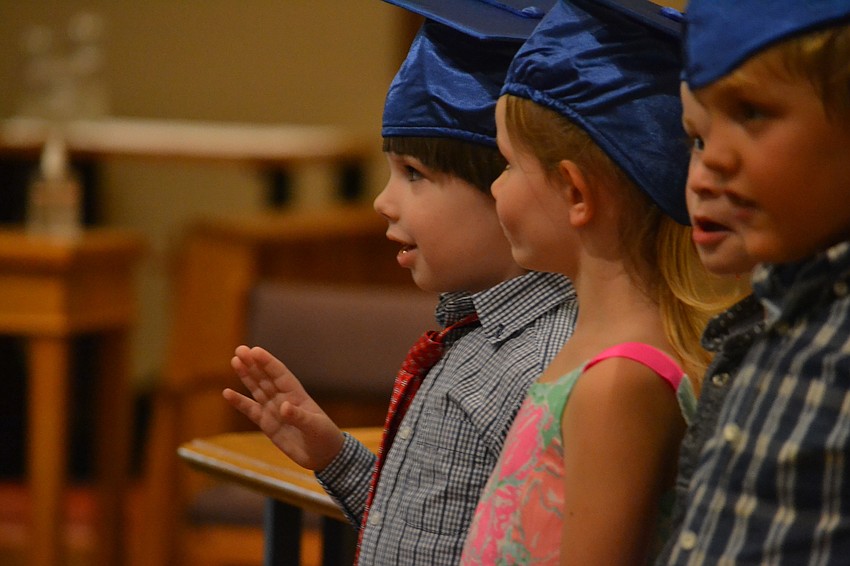 Christopher Kovacs waves to family in the audience.
