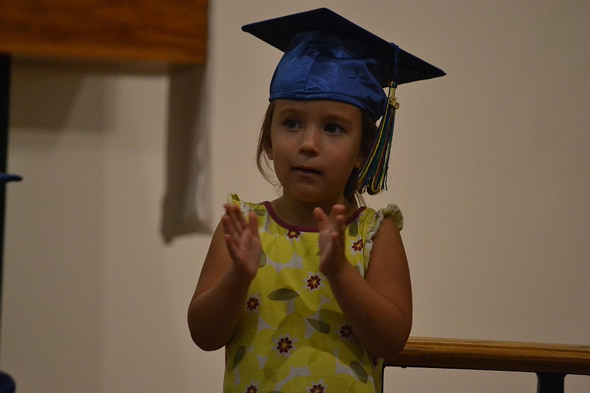 Molly Rauch applauds during the graduation ceremony.