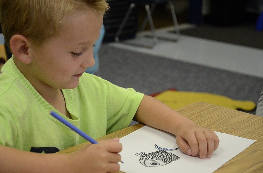 Nicholas Mason colors a fish, an activity some of the seniors planned to go with their story.