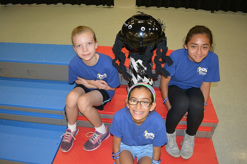 Imagyn Laraway, Yolis Gonzalez and Adriana Guerra of Bashaw covered their water tower in spiders.