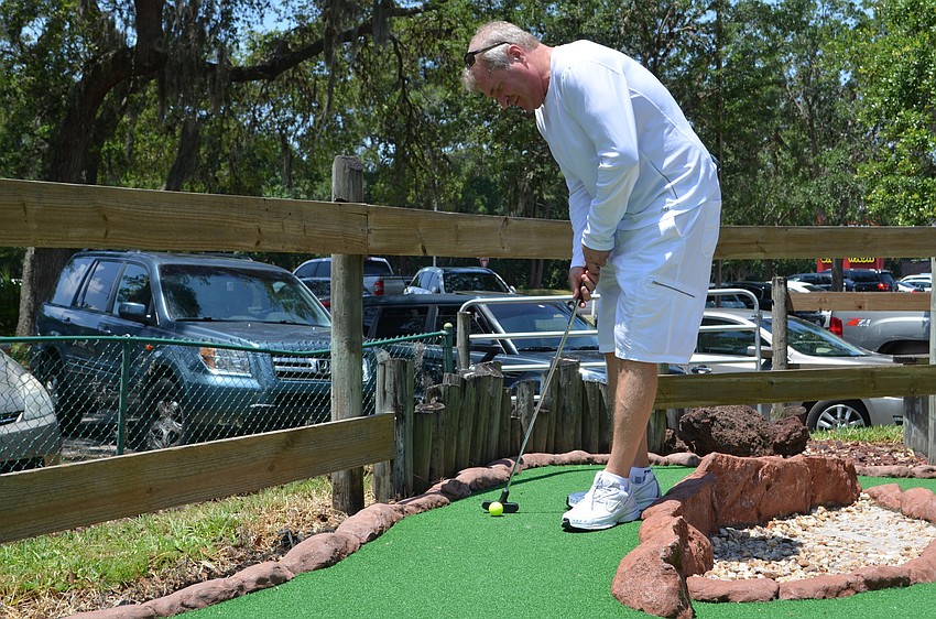 David Striplin putts on the second hole of the course.