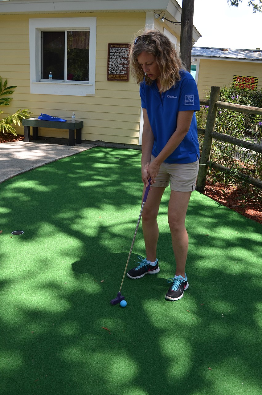 Jeannine Ryan practices her putting on the testing greens.