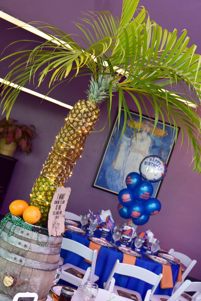 The Table 7 centerpiece featured a palm tree made of pineapples on top of a barrel of rum.