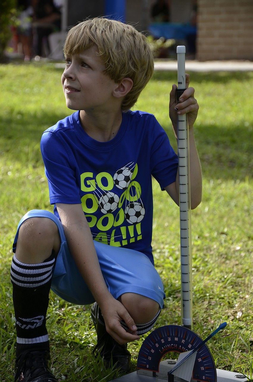 Mason Turner tries out the straw rocket launcher.