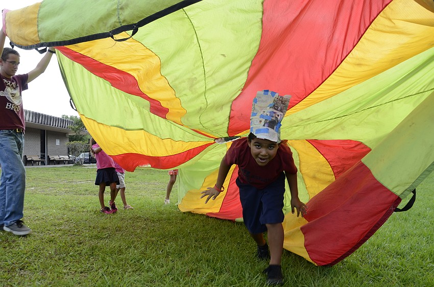 Joshua Salinas runs under the parachute.