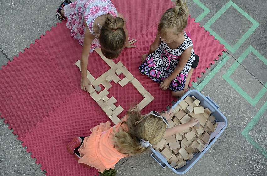 Jaylynn Garber, Allie Garber and Kelly Sportsman build a castle.