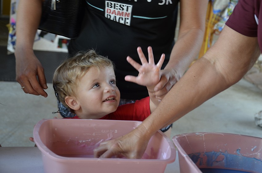 Klyne Hacker giggles at the slime on his hands.
