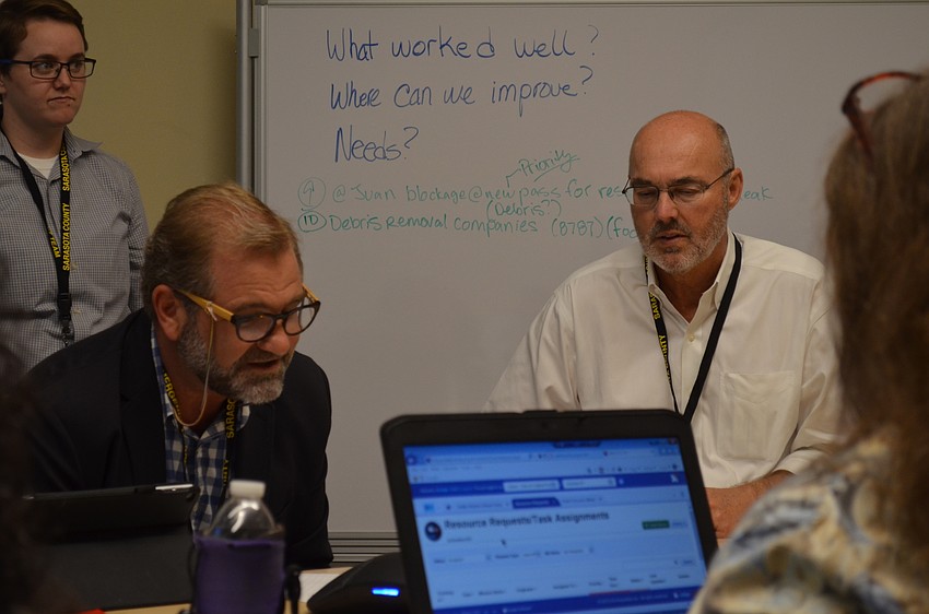 Assistant Town Manager Michael Hein receives a scenario from Deputy Fire Chief Sandy Drake.