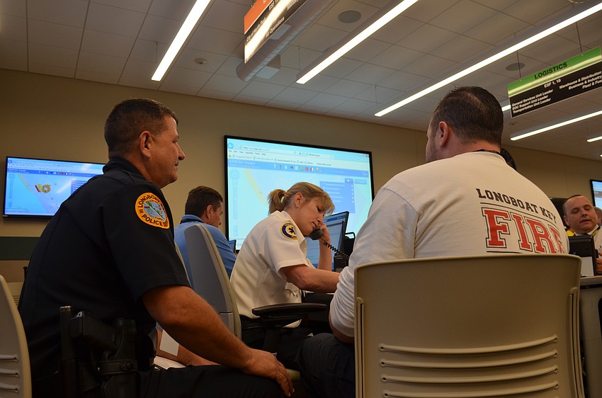 Deputy Fire Chief Sandy Drake relays disaster information to town staff.