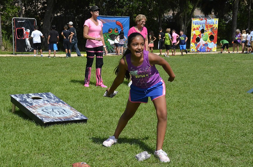 Angelica Cisneros plays corn hole with her friends.
