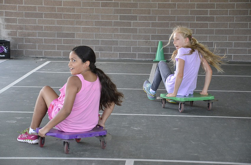Victoria Oliveira and Emily Salambash race during the field day.