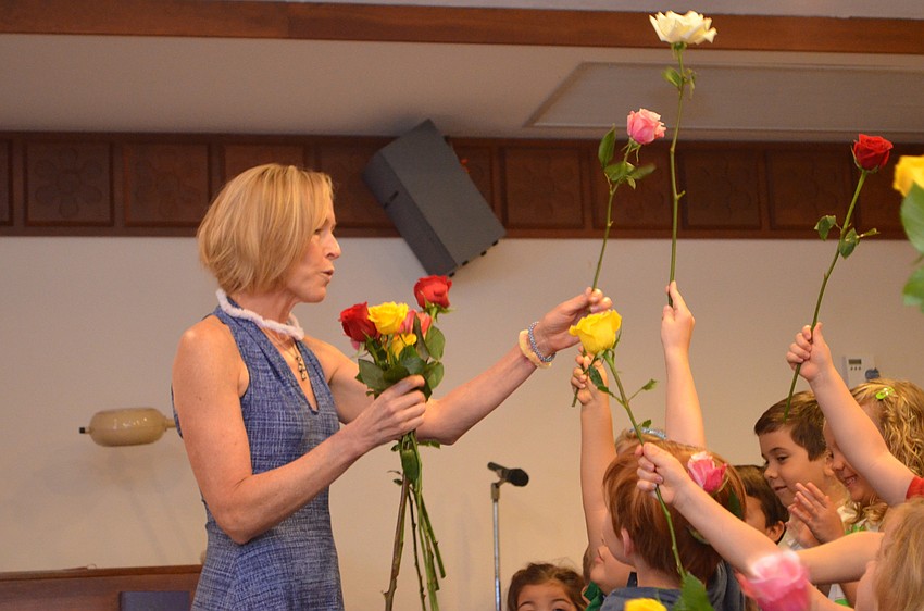 First Presbyterian Preschool Director Clare Carter receives a rose from every graduate as a birthday present.