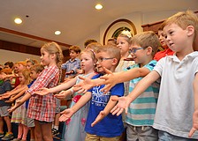Graduates performed songs including "He's Got the Whole World in His Hands."