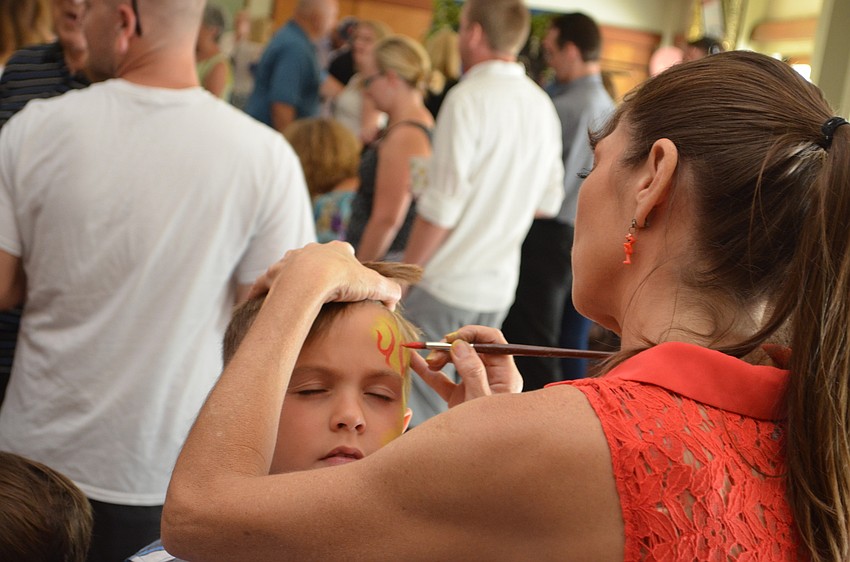 Luke Joiner has his face painted with flames.