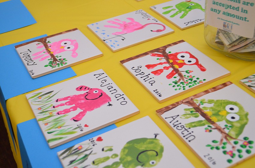 Students painted animals from handprints on tiles to commemorate the school year.