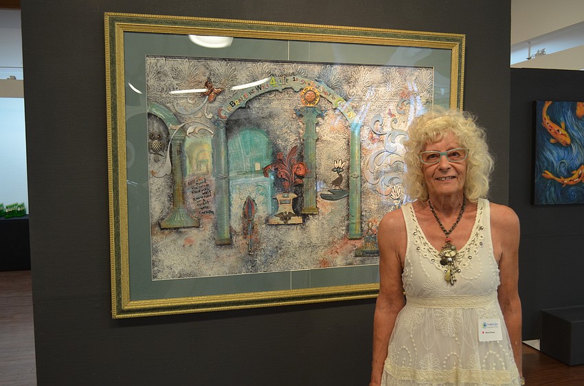 Marcia Brown, of Taylor Ranch Elementary School, with her art, “Sometimes We Wait.”