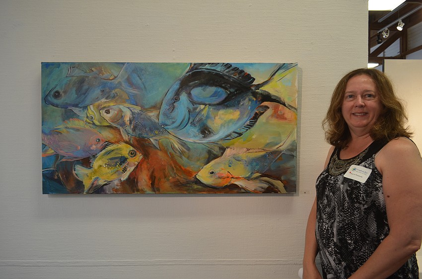 Mary Jo Floryjanski, of Sarasota High School, with her art, “Fish 3, Series 1.”
