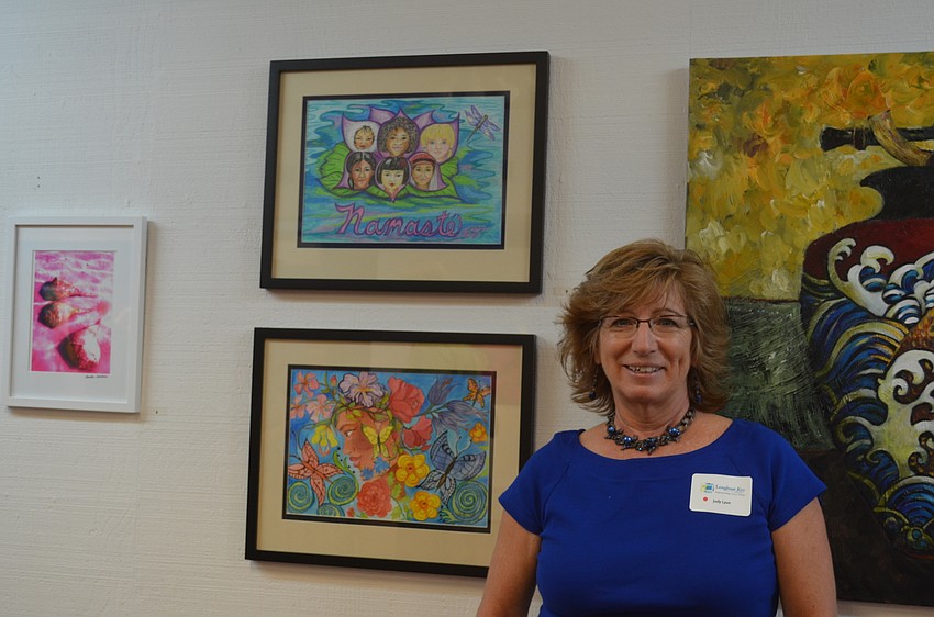 Judy Lyon, of Riverview High School, with her art, “One Blossom, Many Petals” and “Beauty Grows from Within.”