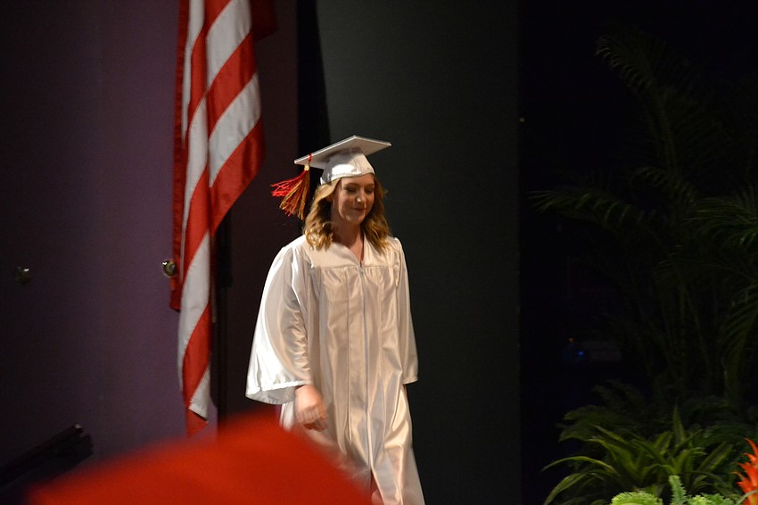 Olivia Collins walks across the stage during the commencement ceremony.