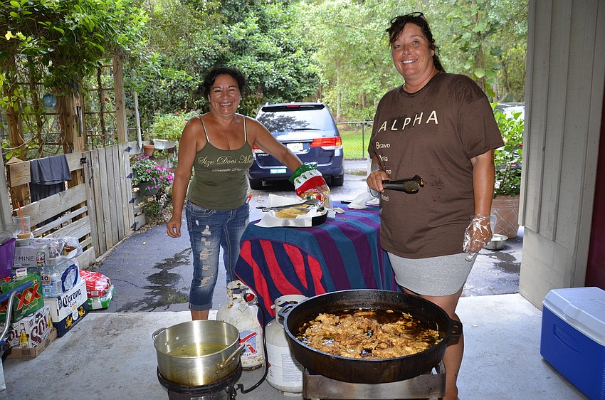 Margie Hernandez, volunteer, and Heike Caspary, event coordinator, both of Bradenton, cook up tacos for attendees.