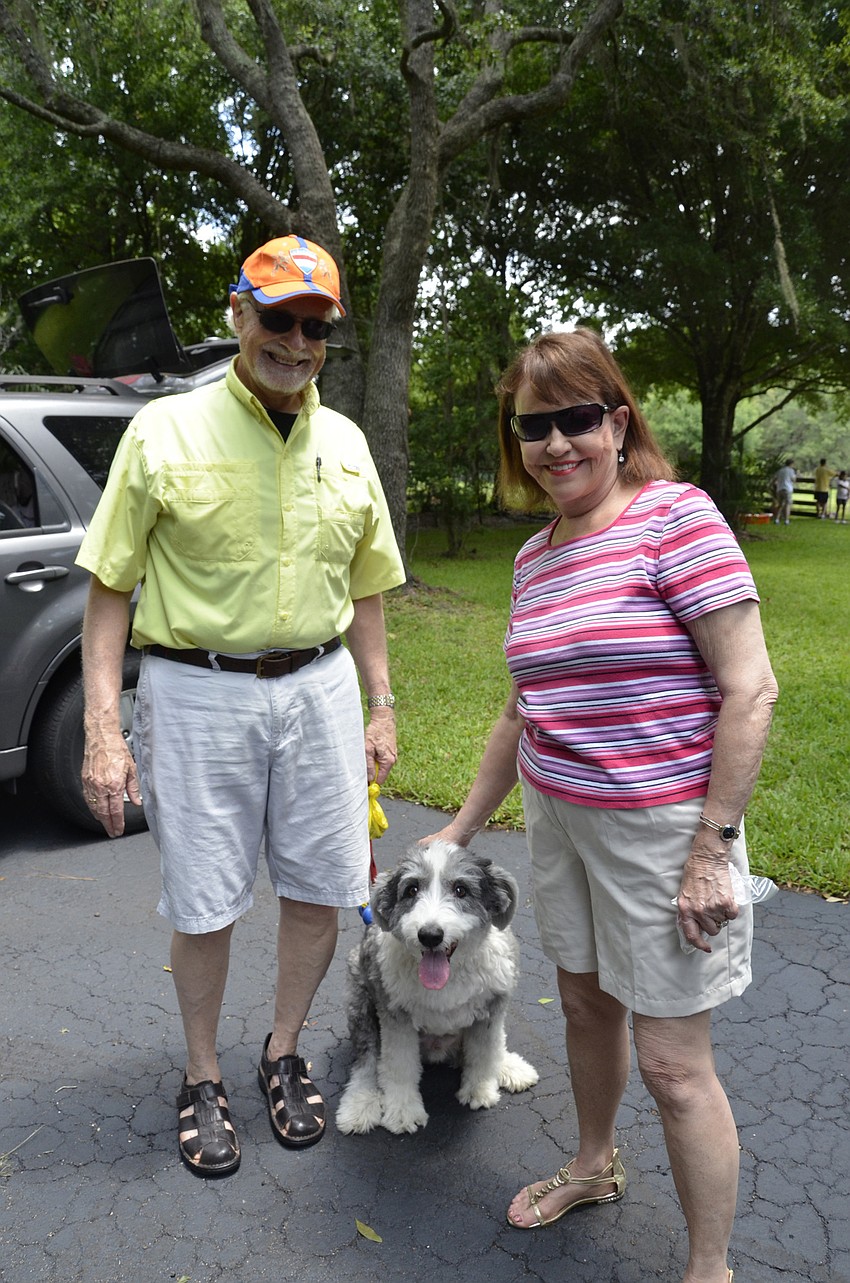 Paul Nelso and Judy Pearson with Bentleu Bear, a old English sheepdog who is shaved down for summer.