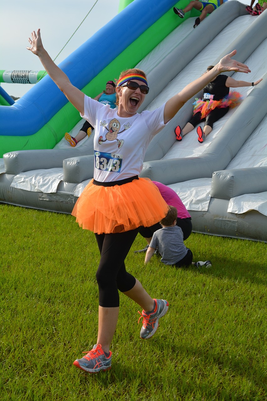 Shawn Gross, of Lakewood Ranch, celebrates making it down the slippery first slide.