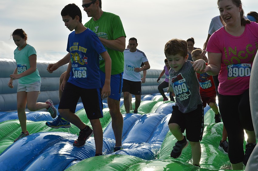 Participants made their way across an assortment of inflatable obstacles, including this wet one.