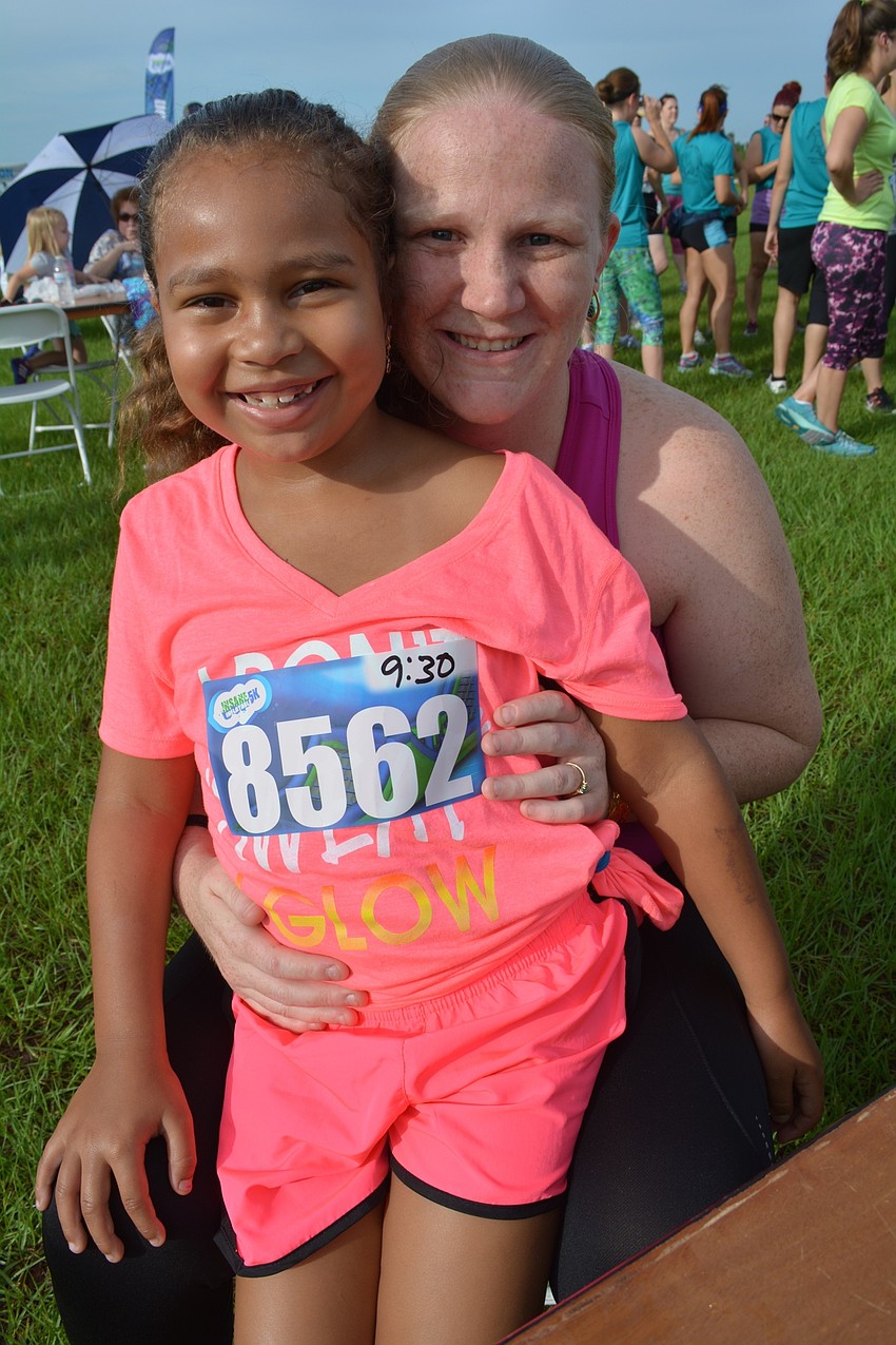 Kalea Core wears herself out with warm up exercises before sitting on the lap of her mom, Jenna Bruno,  for a rest.