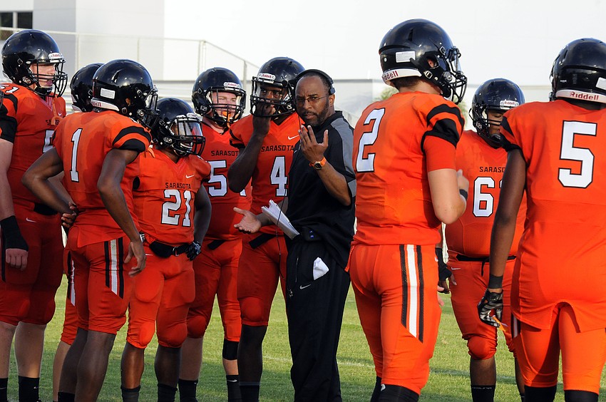 Sarasota coach Brian Ryals talks with his players during the first half of the Sailors spring game versus Naples Gulf Coast May 19.