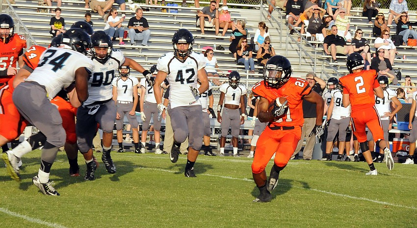 Sarasota running back JaQuan Johnson carries the ball for a short gain.