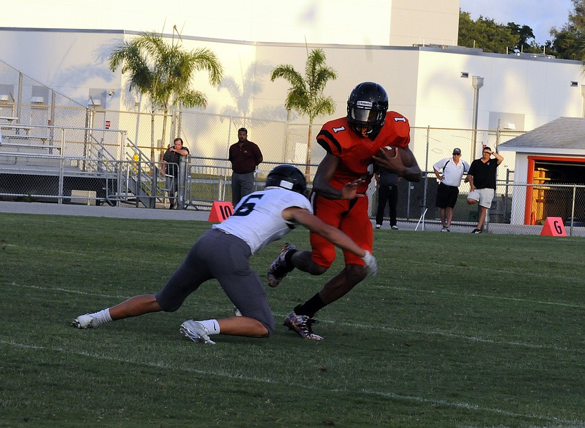 Sarasota wide receiver Dyshone Hayes attempts to break a tackle in the second quarter.