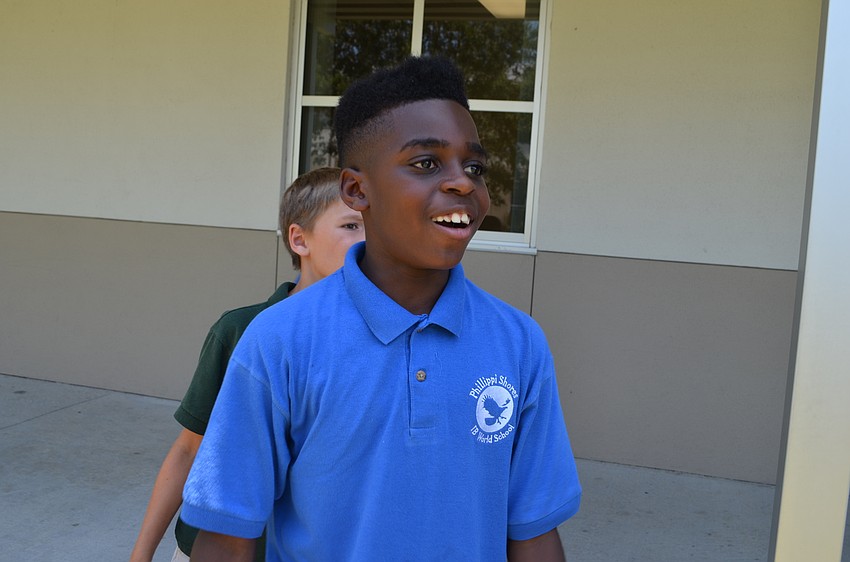 Joshua Henderson is in awe watching his paper airplane glide.