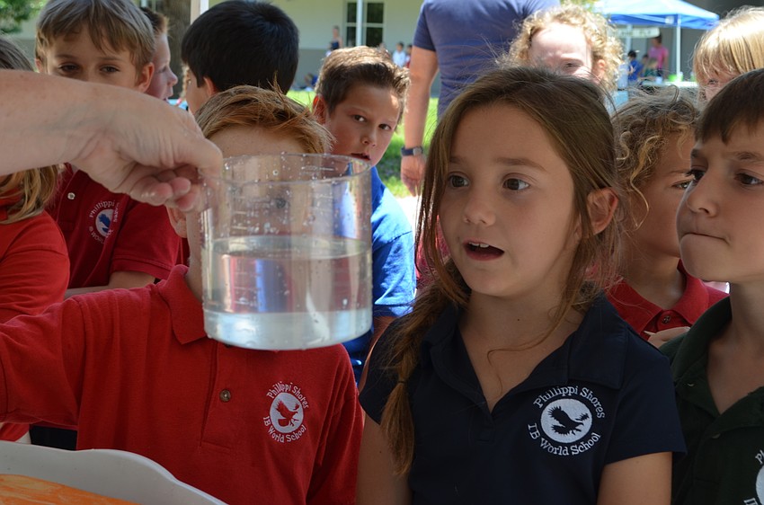 Rylee Roads reads the amount of water she squeezed from a sponge.