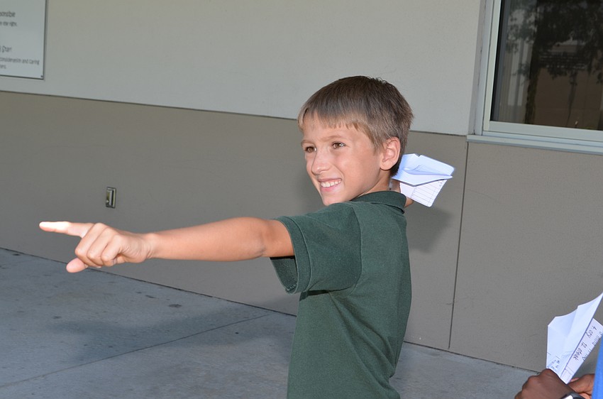 Tide Anderson winds up to launch his paper airplane into the courtyard.