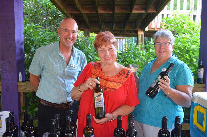Save Our Seabirds board members Robert Gaglio and Janet Arena and guide Barbara Sallee show off Save Our Seabirds wine.