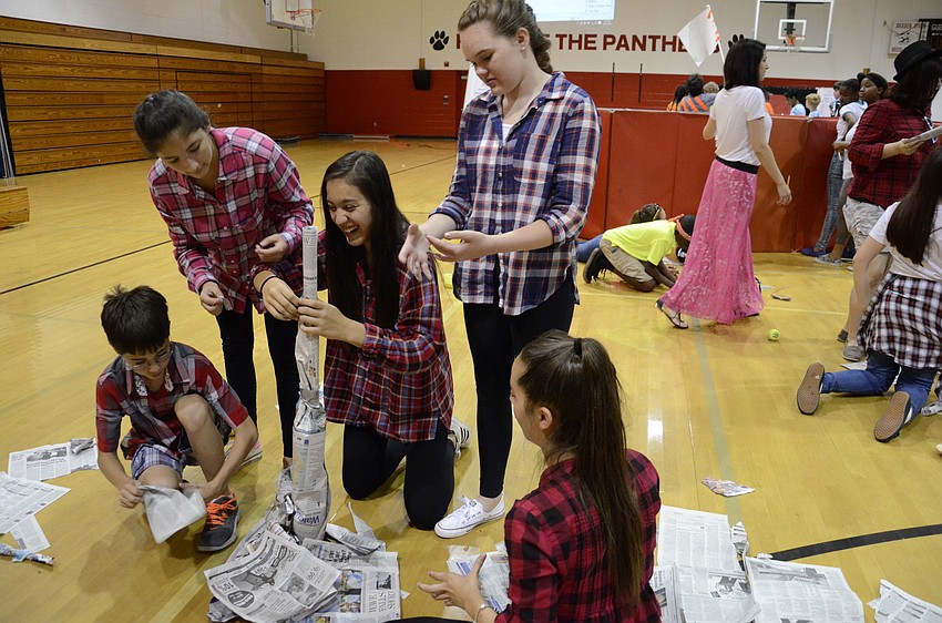 Will McBride, Victoria Rodriguez, Daniella Tapivia, Cora Mabrey and Ina Prodo try to build the tallest newspaper tower they can.
